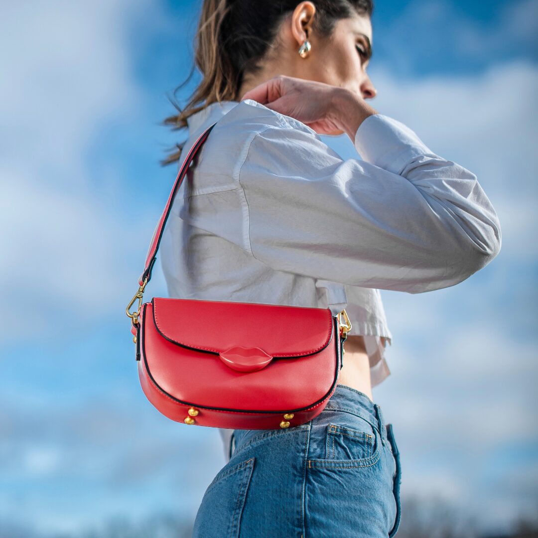 Sac à rabat BISOUS en cuir synthétique ROUGE porté par une mannequin